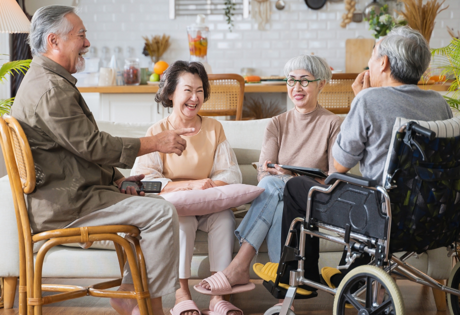 4 elderly people sitting and laughing together